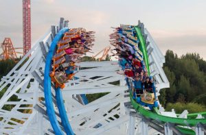 Roller Coaster with riders on two different tracks