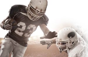 Football players running, tackling